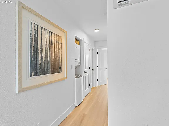 Hallway with in-unit stacked washer and dryer