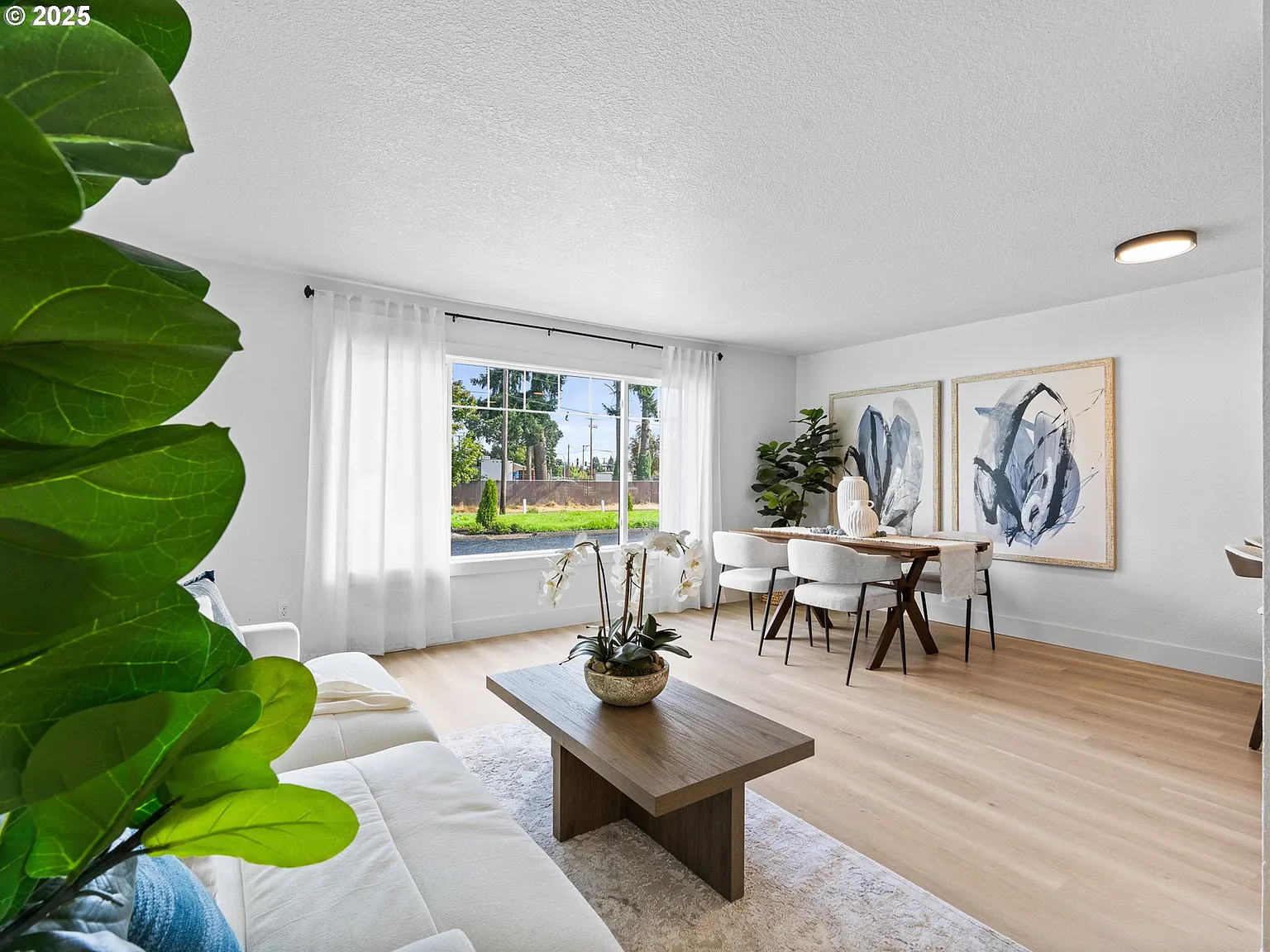 Bright living and dining area with large window